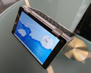 A small convertible laptop running Plasma with its screen folded 270° to be an inverse V shape