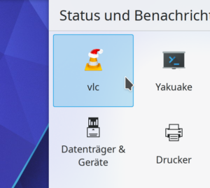 Plasma's system tray popup with mouse hovering the VLC player icon that is sporting a santa hat